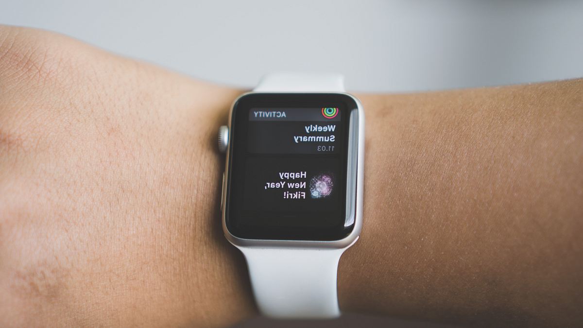 person wearing silver aluminum case Apple Watch with white Sport Band